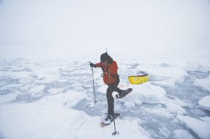 Photo by Lonnie Dupre Top: Eric Larsen traversing water on a cold, dark, Arctic day. He will soon be attempting to be the first person to reach the North Pole, the South Pole and Mount Everest within 365 days.