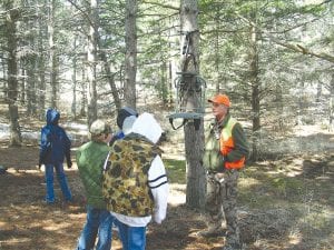 Below: Instructor Doug Klein explains the importance of proper installation of a deer stand.