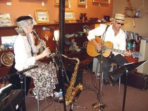 Top Left: Liz Sivertson and John Gruber -  the Sivertones -  perform to an appreciative crowd enjoying art, hors d'oeuvres, and music at Sivertson Gallery at the start of the 2009 Grand Marais Jazz Festival Friday, May 22.