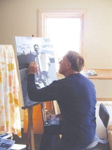 Above: Don Hammer, director of the Grand Marais Art Colony, works on a painting of his grandfather, Louis Vang, on vacation near Lake of the Woods. The painting is taken from a 1947 photograph. 