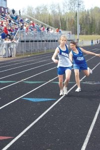 Photos by Karen Lehto Top: Ida Gulbrandsen takes the baton from Adrianna Berglund. Lower left: Michelle Weitz ran season-best times in the one and two-mile races. Lower right: David Bergstrom and his teammates held on for a second in the 4x800 relay.