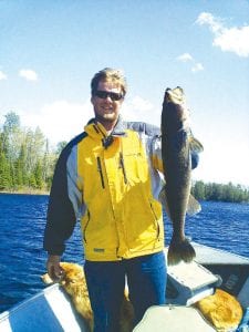 Photo courtesty of Chad Jones Tails of the Trail columnist Cory Christianson and the 33-inch walleye he caught on Lake Saganaga on May 21.