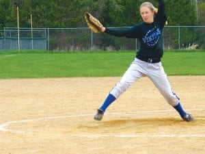 Right: Eighth-grader Sarissa Falk winds up for the pitch in the softball tournament on Saturday, May 9. The softball team defeated Moose Lake- Willow River and Barnum.