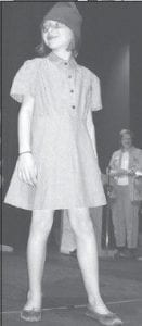 Right: Sarah Toftey modeling a historic Brownie uniform at the Cook County Girl Scout Court of Awards on Thursday, May 21.