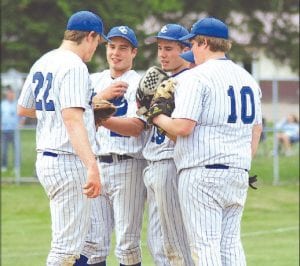 Photo by Jean Mathis The Vikings strategize in their final Section 7A play-off game versus the Chisholm Bluestreaks. (L-R) Sammy Warren, Cody Everson, Casey Everson, Darryl Hansen. The Bluestreaks defeated the Vikings to advance to the state tournament, but the Vikings had a great season, advancing further in play-offs than any other team in Cook County history.