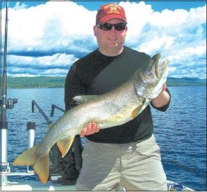 Photo courtesy of Tofte Charters Chris Duffy from Hastings, MN, shows off the 36.5 inch, 14.5 pound lake trout caught in Lake Superior on June 11 with Captain Darren Peck of Tofte Charters.