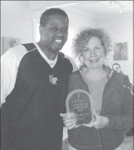 Photo by Michele Jansen, KBEM Kelvin Quarles, General Manager of KMOJ in Minneapolis, chair of the AMPERS nominations committee, presents the AMPERS Broadcaster of the Year award to WTIP's Deb Benedict.