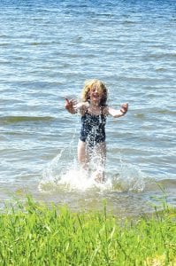 Summer at last! Autumn Anderson, 9, of Lakeville, MN gets in a little summer splash at the McFarland Lake swimming beach.