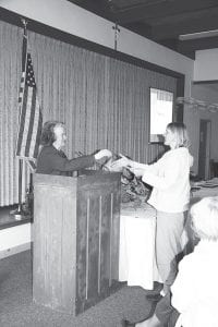 Kirstin van den Berg of Cook County Higher Education accepts the Operation Round Up grant from Operation Round Up Trust board member Mary Petz.