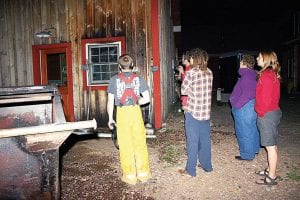 Staff photo/Rhonda Silence Grand Marais Fire Chief Ben Silence (left) and North House staff inspect the damage to the 