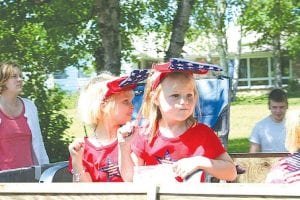 Left: What's a 4th of July parade without Stars & Stripes—and candy? These cute young ladies have it all! Middle: Some Canadian classic car owners decorated with a very unique US-Canada flag.