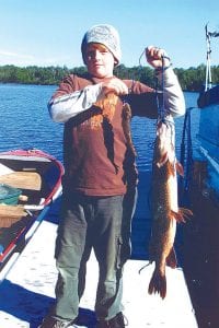 Colton Thompson, son of Jeff Eliasen of Grand Marais, shows off his amazing July 3 catch—two fish at once! He caught the 33-inch, 8 pound 10 ounce northern—on the eight-inch walleye!