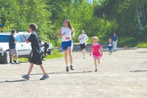 Left: Annie Lynch, 6, Grand Marais won the six-year-old Kid's Race. She also ran the one-mile race, crossing the finish line with her mom, Patty Johnson.