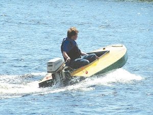 Left: David Hansen takes the boat he built with his uncle Neil Hansen out for its inaugural voyage on Caribou Lake on June 20. Upper Left: The boat—a Sneakbox—in progress. Above: The boat builders, Neil and David Hansen.