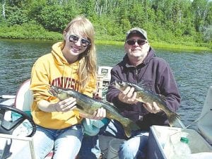 Jon Hibbard and daughter Laura of Albert Lea, MN show off the 23-inch and 19-inch walleyes they caught while fishing with Joe Carlson of Joe's Inland Guide Service at an undisclosed lake. They were using a jig, a leech and a bobber.