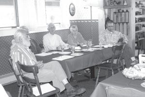 The School District 166 board held a workshop to get to know new superintendent Beth Schwarz at the Birch Terrace in Grand Marais on July 14. Top: The board discussed the strengths—and areas that can be improved—at ISD 166. (L-R) Leonard Sobanja, Board Chair Bill Huggins, Rod Wannebo, Mary Sanders, Eric Kemp. Left: Schwarz started the workshop off on a positive note, asking board members to list the things about ISD 166 that earn a grade of 