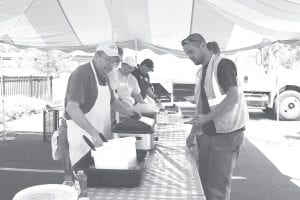 Cam Sjoberg took a break for a lunch at the Como Oil & Propane Customer Appreciation Day in Grand Marais on Wednesday, July 8. Como Oil & Propane showed its appreciation with a hearty barbecue in the Grand Marais municipal parking lot. TJ's Country Store of Mahtowa, MN served up bratwurst and fixings.