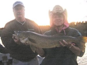 Lori Hommerding with the very nice 28-inch walleye she caught and released on Saganaga Lake on July 18. Friend Rory Smith is helping hold the walleye.