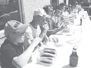 Top Left: Blue Water Café served up hot dogs on the sidewalk for a hot dog eating contest. Last year's winner was Mike Thunborg, New Brighton. He beat his hungry competition by eating five hotdogs in 3 minutes 45 seconds.