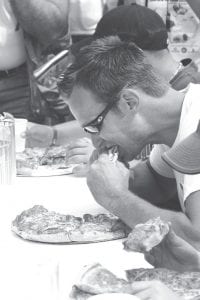 Above Right: However, the pizza-eating contest is very tempting! Contestants gobble down a 12-inch thick crust pepperoni pizza. John Henneman has won the competition for two years in a row, 2007-2008.