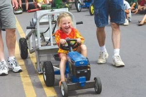 Another chance for kids to get behind the wheel is at the Fisherman's Picnic Tractor Pull. It's hard work, but look! It's fun!