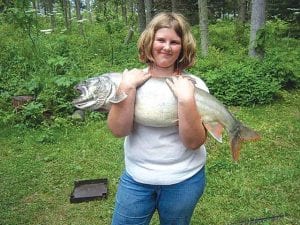 Photo by Misty Schliep Mikala Schliep had an even better day of fishing on Sunday, July 26, at Isle Royale, with Tim Schliep and Kelly Schliep on the Knott Enuff. She was happy she caught a trout bigger than her brother's. At press time she has the lead in the Buck's Big Fish Contest.