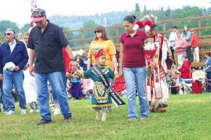 Rendezvous Staff photos/Rhonda Silence The youths who will serve as the 2009 Grand Portage Royalty were announced at the Grand Portage Traditional PowWow on Saturday, August 8. (Clockwise from upper left) Former Princess Chelsey Sorenson and PowWow Committee member Dana Logan help new Senior Brave Jaden Aubid with his honorary sash. Senior Princess Autumn Clearwater-Day in a beautiful yellow and orange shawl dress. Grand Portage Braves (L-R) Tiny Tot Brave John Pierre, Junior Brave Patrick Pierre Jr., Senior Brave Jaden Aubid. Tiny Tot Niimin LeGarde, a jingle dancer, looked very serious about her new duties.