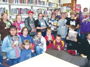 Photo courtesy of the Grand Marais Library Lower Left: Just before the end of the school last year, Julie Viren's fifth grade students made a field trip to the Grand Marais Public Library to stock up on summer reading. They are pictured with the books they were checking out. The Library also saw visits from 116 other students at the end of the school year.