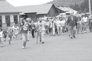 Left: Young and old, in workout clothes or voyageur garb, walkers set off to walk one or three miles in the Rendezvous Days Walk-Run.