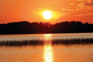 Photo by Nancy Ullrich There is a slight fall chill in the air and daylight hours are getting shorter. But fall also brings brilliant sunsets, like this one on Poplar Lake.