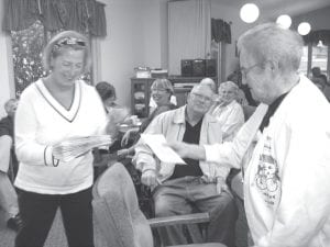 Staff photo/Jane Howard Eleanor Waha (right) accepts a check from Katie Anderson on behalf of one of the numerous organizations she volunteers for. The hours community volunteers spent helping 1st and 2nd Thrift Shop in Grand Marais this last year brought a profit of $40,000.14 that was then given to 37 Cook County nonprofits chosen by the volunteers. The money was dispersed at a celebration coffee at the Senior Center in Grand Marais Tuesday, August 18, 2009.