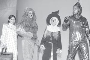 Photo courtesy of Grand Marais Playhouse Off to see the Wizard! (L-R) Dorothy (Brooke Sherer), the Cowardly Lion (Dave Seaton), the Scarecrow (Sean MacDonnel), and the Tim Man (Jack Nickolay).