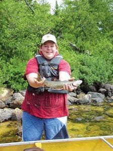 Photo by Nancy H. Tom B. from Prior Lake caught his first lake trout at Seagull Lake on August 8. The trout gave a good fight! Tom used a Crocodile spoon in 40 feet of water. The trout added to a great Boundary Waters trip with his Aunt Katie, Uncle John, and cousins Eileen, Shannon and Sarah. Friends Nancy and Tom from Grand Marais joined in on the fun.