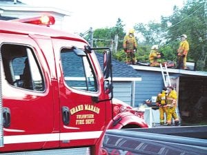 Staff photo/Hal Kettunen The Grand Marais Fire Department cut a hole in the roof over the Birch Terrace kitchen to completely extinguish the fire on August 24.