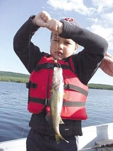 Photo by Joe Carlson Arthur Louey, of South Minneapolis, with his first-ever walleye, caught at an undisclosed lake, while fishing with Joe's Inland Fishing.