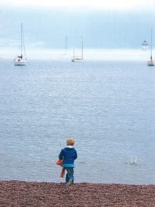 This young man enjoyed a misty day on the Grand Marais harbor with a traditional pastime, rock-skipping.