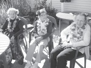 Above: Lovely ladies at Luau. (L-R) Mable Stoltz, Sylvia Hunt and Grace Sieckert looked lovely for the annual Hawaiian Luau on August 26. The weather cooperated for a great evening outdoors on the patio with food, live music by The Sivertones and lots of fun.