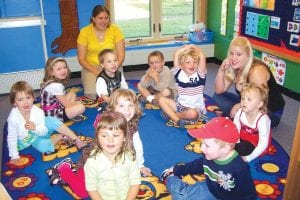 Above: Saplings Preschool kids and new staff Alexis Berke and Jessica Heil-Nelson, have a great first day! There are 13 students registered for preschool this year, with room for more. To register your child, contact Birch Grove at (218) 663-0170. Left: Bella Hendrickson, a new kindergartener was happy to take part in the first day of school Bell Ringing Ceremony!