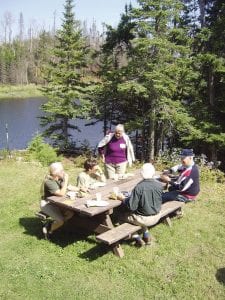 Staff photos/Jane Howard Above left: The last meal to be served inside the historic Chik-Wauk Lodge was enjoyed by members and supporters of the Gunflint Trail Historical Society Monday, August 31, 2009. The building will open as the Chik-Wauk Museum and Nature Center next summer. Top right:This is a rendering of a wall-size mural that Split Rock Studios will be painting on the inside wall of Chik-Wauk Museum. It features natural elements found in the vicinity. Split Rock Studios will be installing the exhibits, which will be ready for a grand opening celebration July 4, 2010. Bottom right: The weather was beautiful for the Gunflint Trail Historical Society annual picnic at Chik-Wauk. Trails around the property are now open.