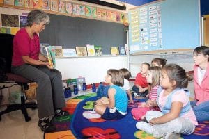 Oshki Ogimaag kindergarten teacher Mary Bjorngjeld reads to her class (L-R) Rhonnie Poyirier, Tucker Bakke, Daunte Deschampe, Niimin LeGarde, Alice Koster, Nashalla Deschampe. Bonita Poitra in back.