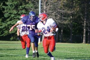 A very determined senior linebacker Mike Austin on the blitz. Austin pressured the Chisholm Bluestreak quarterback into three errant throws at the September 4 game.