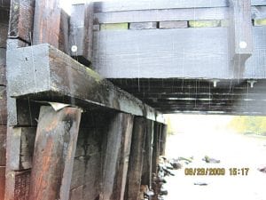 Photos courtesy of Cook County Highway Department The 50-year-old bridge at the end of the Arrowhead Trail may have reached the end of its lifespan. Left: The bridge's vertical timber pilings are starting to rot. Above: Car tires could be damaged or possibly drop through the bridge planks.