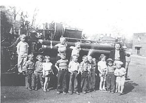 Tom Toftey shared this picture of the days before pre-school. Evelyn Toftey taught nursery school to local four- and five-year-olds. This photo is of a field trip to see the city of Grand Marais' new fire engine from around 1950. The children are (L-R, front) Richard Johnson, David Blackwell, Ann Humphrey (Cervenka), Clayton White, David Johnson, Tom Toftey, Sandi Schuster (Everson), a young boy believed to be Duane Ege, LaVerne Linnell, Terry Scott, and Bob Helmerson. (L-R, back) David Skoog, Neil Hall, Bob Toftey, and Evelyn (Toftey) Sjoberg.