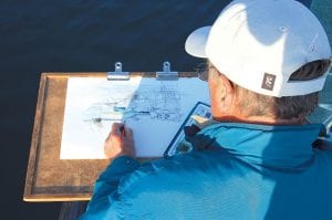 Photo by Amy Demmer Above: Local Artist David Hahn paints boats in the Grand Marais harbor during the Quick Paint event.