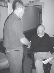 Left: Jeff Kern (left) shakes hands with Cook County Tennis Association President Gene Glader. Kern received a certificate of appreciation from Glader on behalf of the association for all his volunteer work on the design and construction of the new tennis courts, viewing area, storage building, and backboard.