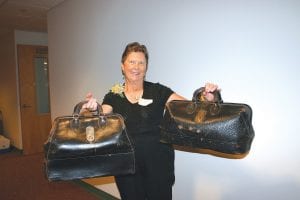 Above: Rosemary Lamson holds the medical bags used for many years by her father, Dr. Wallace R. Smith. At the hospital open house, Lamson shared memories of living in a Cook County doctor’s household when there was no hospital. The medical bags—and the tools that were carried inside—are now on display at the Cook County Historical Society Museum.