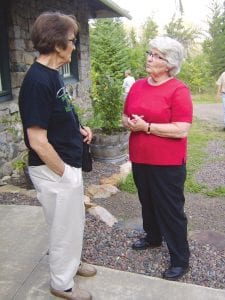 Staff photos/Jane Howard Author/photographer Betty Hemstad (right) talks to Bernice Howard of Grand Marais outside Chik-Wauk Lodge. Hemstad was signing her book Wildflowers of the Boundary Waters: Hiking through the Seasons. Chik-Wauk was one of three lodges featured during the second annual tour of Gunflint lodges, which features samples of the recipes found in A Taste of the Gunflint Trail, a book of lodge recipes and stories by women of the Gunflint Trail.