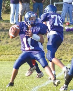 Photo by Gary Siesonnop Mike Austin defends quarterback Kale Boomer. Boomer connected on a 65-yard pass with tight end Dylan Quaife for a touchdown.