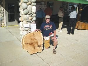 Ranger Bob Maki of the Minnesota Department of Natural Resources (DNR) with the winning entry in the “Big Cookie Contest” at the annual Minnesota Timber Producers Equipment Expo at the Itasca County Fair grounds in Grand Rapids, MN.