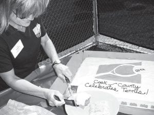 Lee Bergstrom serves cake at the celebration of the new courts in Grand Marais.